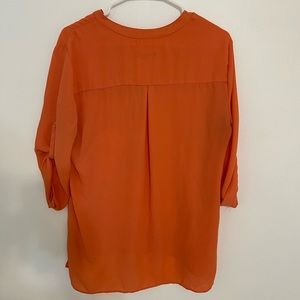 Salmon colored soft mesh women’s top.